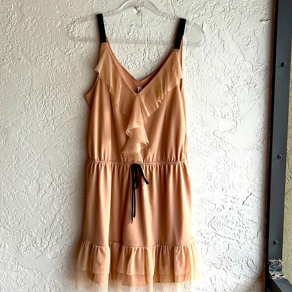 Tan dress with black stripes and black tie.